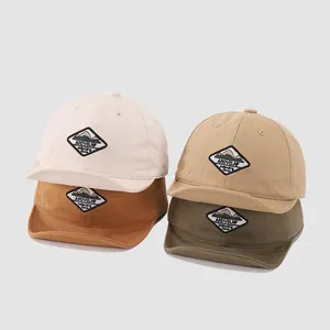 Baby soft brim baseball caps in four colors featuring mountain embroidered patches