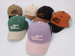 Detail view of multi-color kids baseball caps featuring 3D letter embroidery and contrast bills