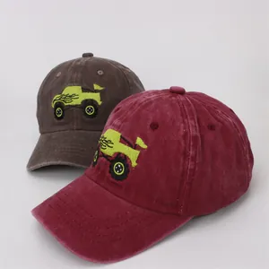 Detail of embroidered monster truck on washed cotton vintage style baseball caps