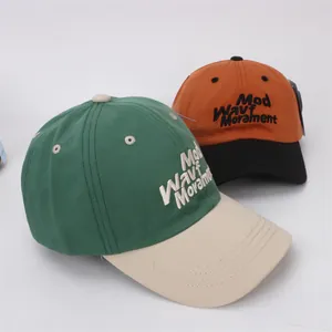 Kids color-block baseball caps with letter embroidery in green and orange cotton