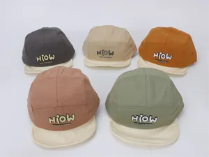 Detail view of cotton camp caps in multiple colors with embossed HIOW design text
