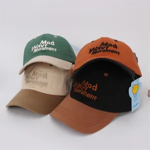 Detailed view of color-blocked kids baseball caps with 3D letter embroidery in four colors