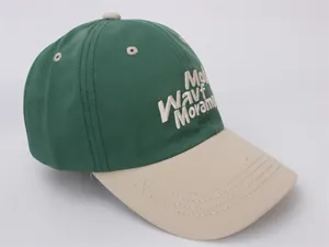Close-up of dual-tone cotton baseball cap with beige 3D embroidery and twill fabric texture