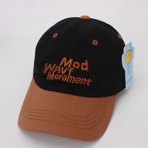 Close-up of contrast stitch baseball cap with MWM 3D letter embroidery and side tag