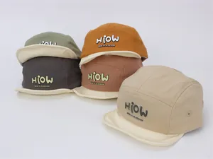 Macro detail of multi-color five-panel baby baseball hats with canvas texture and logo