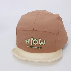 Detail of color-block baby baseball cap with soft brim and HIOW decorative patch