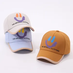 Kids baseball caps with smiley face design in beige, light blue and yellow colors