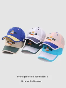 Detail showing various colors of breathable mesh kids' baseball caps with bear embroidery