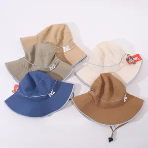 Vista piatta di cappelli da sole per bambini in vari colori con strisce riflettenti
