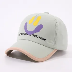 Detail of mint green baseball cap with smiley face print and contrast piping