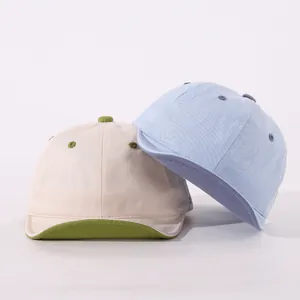 Detail of soft brim baby baseball caps with GOOD LUCKY embroidery and cotton texture