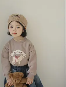 Detail of khaki cotton beret hat featuring embroidered BOTNESS 1998 text for children