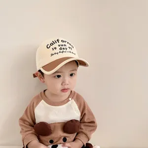 Detail of baby bear hoodie with 3D ears and two-tone baseball cap in waffle knit fabric