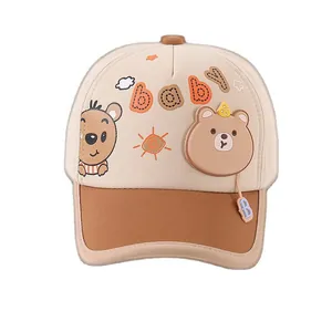 Toddler baseball cap with bear pendant and embroidered baby text in beige and brown
