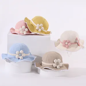 Detail of baby sun hats featuring lace edges and 3D fabric flowers in five soft colors