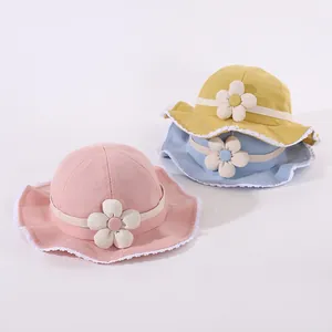 Cute baby sun hats with lace trim and fabric flowers in pink, yellow, and blue colors