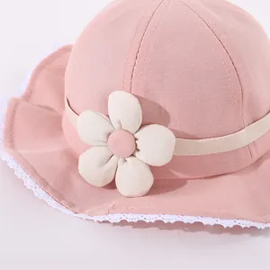 Pink cotton toddler sun hat with a 3D floral accent and white lace trim along the brim