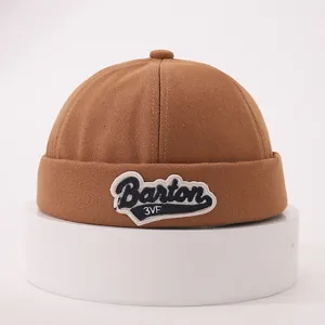 Detail of vintage brown cotton canvas docker hat with Barton 3VF letter embroidery