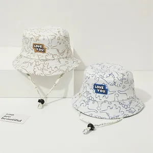 Kids dinosaur print sun hats in beige with Love You label and adjustable chin strap