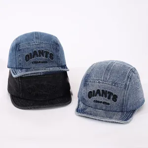 Detail of denim camper caps featuring Giants embroidery and high-quality stitching texture