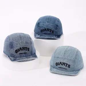 Three shades of denim baseball caps with GIANTS embroidery on white display stands