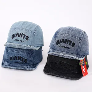 Detail view of denim baseball caps featuring vintage wash and GIANTS letter embroidery