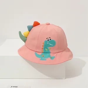 Detail of pink cotton sun hat with cartoon dinosaur embroidery and 3D decorative fins