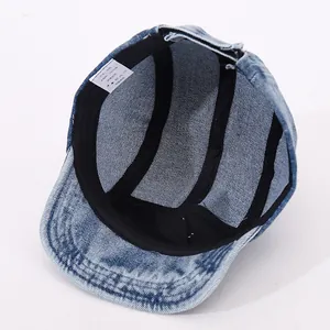 Internal detail of denim baby hat showing 100% cotton sweatband and neat stitching