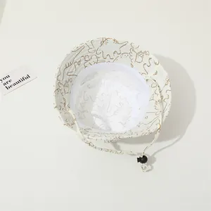 Detail of dinosaur print baby sun hat with breathable mesh lining and windproof strap