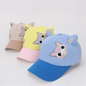 Detailed view of three-color cartoon baseball caps with cat ears and embroidery