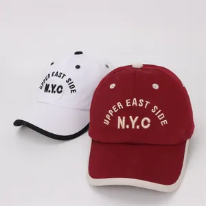 Close-up of Upper East Side N.Y.C. embroidery on kids cotton twill baseball caps