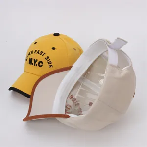 Yellow and beige kids baseball caps with NYC embroidery and adjustable strap