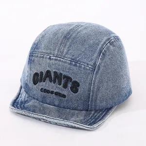 Close-up of black 3D embroidery GIANTS logo on premium light blue denim 5-panel cap