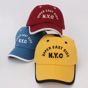 Detailed view of children's NYC baseball caps in red, blue, and yellow with high-quality embroidery