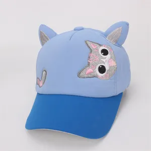 Detail view of children's baseball cap with 3D cat ears and blue patchwork cotton fabric
