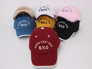 Detail of multi-color kids baseball caps with embroidered NYC and Upper East Side letters