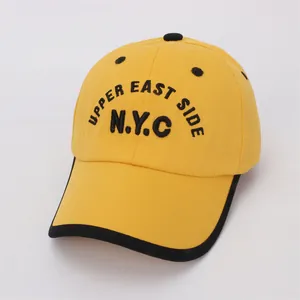 Close-up of yellow children's NYC baseball cap featuring black Upper East Side embroidery