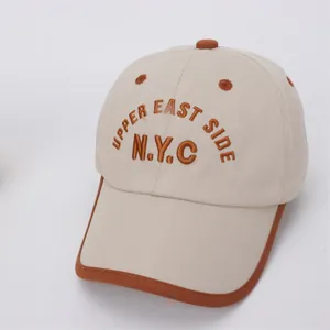 Detailed top view of kids NYC baseball cap with Upper East Side embroidery and brown piping