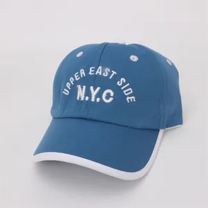 Detailed white embroidery of UPPER EAST SIDE N.Y.C on a blue cotton canvas baseball cap
