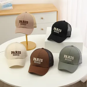 Detail of PARIS embroidered mesh trucker hats in various colors with breathable design