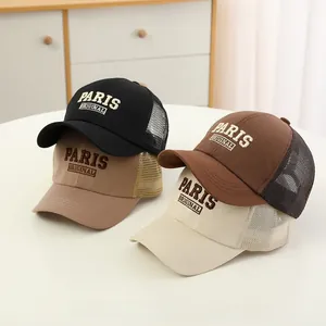 Detail of four breathable mesh baseball caps with Paris Original 3D embroidery on table