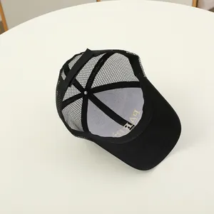 Detailed view of black mesh trucker hat with Paris embroidery and adjustable snapback closure