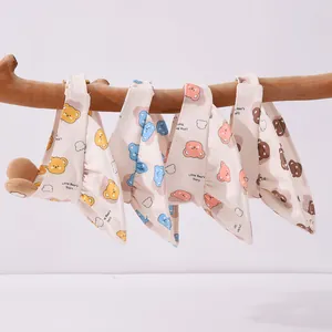 Close-up of cute cartoon bear patterns on toddler sun hats hanging on a wooden branch