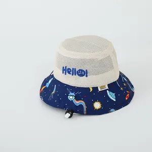 Detail view of baby sun hat featuring breathable white mesh and blue space theme cartoon prints