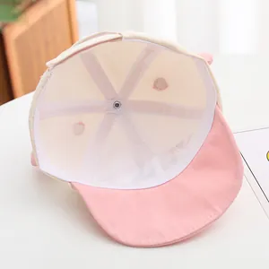 Detailed interior of a soft pink baby baseball cap showing breathable cotton lining