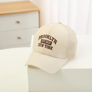 Detailed close-up of beige mesh baseball cap with Brooklyn New York embroidery