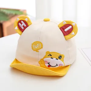 Close-up of baby baseball cap with yellow bunny ears and cute hippo cartoon embroidery