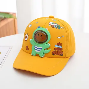 Detail of yellow kids baseball cap featuring 3D dinosaur with transparent face shield