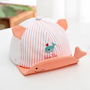 Close-up of baby mesh baseball cap with whale embroidery and orange striped ears