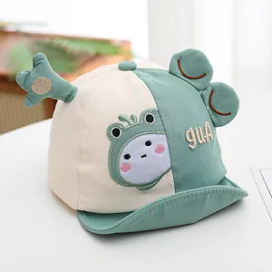 Detail of baby baseball cap with green frog eyes and 3D ears on corduroy fabric